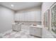 Laundry room with sink, cabinetry, quartz countertops, and eye-catching tile floors at 4354 Persimmon Rd, Lancaster, SC 29720