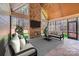 Bright living room with a statement stone fireplace, floor-to-ceiling windows, and neutral decor that complements the wooded scenery at 4354 Persimmon Rd, Lancaster, SC 29720