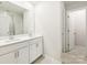 A bright bathroom featuring a double sink vanity with white cabinets and a large mirror at 5013 Poplin Vly, Cherryville, NC 28021