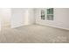 A spacious bedroom with neutral carpet and large windows offering plenty of natural light at 5013 Poplin Vly, Cherryville, NC 28021