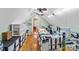 Attic craft room featuring vaulted ceilings, hardwood floors, and two ceiling fans at 5053 Marci Ln, Belmont, NC 28012