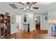 Upstairs hallway featuring hardwood floors, a ceiling fan, and an arched doorway at 5053 Marci Ln, Belmont, NC 28012