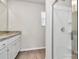 Bathroom featuring a vanity with granite counters, a walk-in shower, and vinyl floors at 508 Hawley St, Charlotte, NC 28214