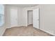 Bright bedroom featuring neutral carpet and multiple closets at 508 Hawley St, Charlotte, NC 28214