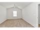 Bright bedroom featuring neutral carpet, vaulted ceilings, a ceiling fan, and a window at 508 Hawley St, Charlotte, NC 28214