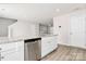 Open kitchen with stainless steel dishwasher, white cabinets, and granite countertops at 508 Hawley St, Charlotte, NC 28214