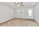 Bright living room featuring carpet, a ceiling fan, and a large window at 508 Hawley St, Charlotte, NC 28214