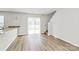 Bright living room with sliding glass doors, wood-look floors and stairs to the second level at 508 Hawley St, Charlotte, NC 28214