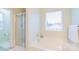 Bright bathroom featuring a soaking tub with jets, separate shower, and a large window at 552 Montgomery Dr, Rock Hill, SC 29732