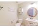 Clean bathroom features a white vanity with storage and a round mirror complementing the light green walls at 552 Montgomery Dr, Rock Hill, SC 29732