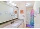 Bathroom featuring a large mirror, vanity with granite counters, and shower with colorful curtain at 552 Montgomery Dr, Rock Hill, SC 29732