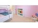 Pink bedroom featuring bunk beds and a bright white bookshelf with colorful books at 552 Montgomery Dr, Rock Hill, SC 29732