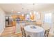 Open-concept dining area with a view of the modern kitchen featuring stainless steel appliances and breakfast bar at 552 Montgomery Dr, Rock Hill, SC 29732