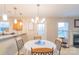 Cozy dining area with a white tablecloth, decorative chandelier and easy access to both the kitchen and fireplace at 552 Montgomery Dr, Rock Hill, SC 29732
