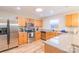 Well-lit kitchen features stainless steel appliances, wood-look flooring, and granite countertops with breakfast bar at 552 Montgomery Dr, Rock Hill, SC 29732