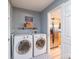 Convenient laundry room with modern washer and dryer units, shelf storage, and direct access to the kitchen at 552 Montgomery Dr, Rock Hill, SC 29732