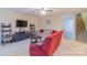 Comfortable living area featuring a plush sofa, entertainment center, and open staircase at 552 Montgomery Dr, Rock Hill, SC 29732