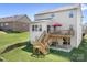 Back exterior view of the house with a deck, stairs, and lawn at 7217 Kenyon Dr, Denver, NC 28037