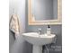 Bathroom features a pedestal sink with decorative mirror and soap dispenser at 7217 Kenyon Dr, Denver, NC 28037