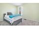 Cozy bedroom with a comfortable bed, soft carpet, and a bright window at 7217 Kenyon Dr, Denver, NC 28037