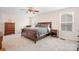 Spacious bedroom featuring a ceiling fan, carpeted floor, and a well-lit window at 7217 Kenyon Dr, Denver, NC 28037