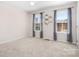 Spacious bedroom with two large windows with modern ceiling fan, neutral paint, and plush carpeting at 7217 Kenyon Dr, Denver, NC 28037