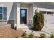 Inviting front entrance with a black door, decorative sidelight, and stone accents at 7217 Kenyon Dr, Denver, NC 28037