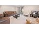 Cozy living room with plush seating, neutral tones and a sliding glass door to the outside at 7217 Kenyon Dr, Denver, NC 28037