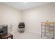 Finished room with neutral walls, fan, rolling metal rack, accent chair, and carpeted floor at 7217 Kenyon Dr, Denver, NC 28037
