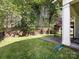 Manicured backyard, featuring a lush lawn, privacy fence, and a covered patio at 8830 Beaver Creek Dr, Charlotte, NC 28269