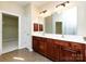Bathroom showcasing a double vanity with dark wood cabinets and a tile floor at 8830 Beaver Creek Dr, Charlotte, NC 28269