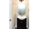 Small bathroom with a black vanity and a decorative mirror at 8830 Beaver Creek Dr, Charlotte, NC 28269
