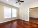 Sunlit room with hardwood floors, ceiling fan, and doorway to another room at 8830 Beaver Creek Dr, Charlotte, NC 28269