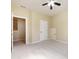 Bedroom with carpet, ceiling fan, and natural light, with doorway to walk-in closet at 8830 Beaver Creek Dr, Charlotte, NC 28269