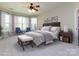 Serene primary bedroom boasts large windows, neutral tones, and a cozy sitting area for relaxation at 8830 Beaver Creek Dr, Charlotte, NC 28269
