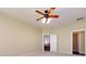 Bedroom with carpet, a ceiling fan with lights, and an open doorway to an en-suite bathroom with a soaking tub at 8830 Beaver Creek Dr, Charlotte, NC 28269