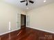 Bedroom featuring hardwood floors, ceiling fan, and glass French doors at 8830 Beaver Creek Dr, Charlotte, NC 28269