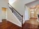 Inviting entryway with hardwood floors, staircase, and access to other rooms in the home at 8830 Beaver Creek Dr, Charlotte, NC 28269