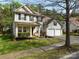 Charming two-story home with a well-manicured lawn, a two-car garage, and inviting front porch at 8830 Beaver Creek Dr, Charlotte, NC 28269