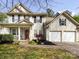 Charming two-story home with a well-manicured lawn, a two-car garage, and lovely front porch at 8830 Beaver Creek Dr, Charlotte, NC 28269