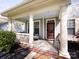 Inviting covered front porch with classic columns and a brick-lined entryway at 8830 Beaver Creek Dr, Charlotte, NC 28269
