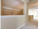 Hallway with neutral paint, trim and carpet. View of Bonus Room at end of hall at 8830 Beaver Creek Dr, Charlotte, NC 28269