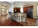 Kitchen with breakfast bar and decorative chairs with stainless steel refrigerator at 8830 Beaver Creek Dr, Charlotte, NC 28269