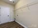 Functional laundry room with vinyl flooring and shelving at 8830 Beaver Creek Dr, Charlotte, NC 28269
