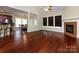 Open-concept living area featuring hardwood floors, a fireplace, and dining room access at 8830 Beaver Creek Dr, Charlotte, NC 28269