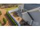 A fenced backyard featuring a paved patio, and neatly trimmed hedges, providing a private outdoor space at 1005 Headwaters Ct, Matthews, NC 28104