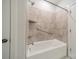 Bathtub and shower combo with tile surround and modern fixtures at 1005 Headwaters Ct, Matthews, NC 28104