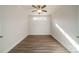 Minimalist bedroom with tray ceiling, ceiling fan, and hardwood floors at 1005 Headwaters Ct, Matthews, NC 28104