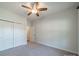 Bright bedroom featuring carpeted floors, a ceiling fan, and a closet at 1005 Headwaters Ct, Matthews, NC 28104