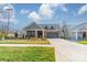 Attractive single-Gathering home featuring a neatly manicured lawn and a wide driveway at 1005 Headwaters Ct, Matthews, NC 28104